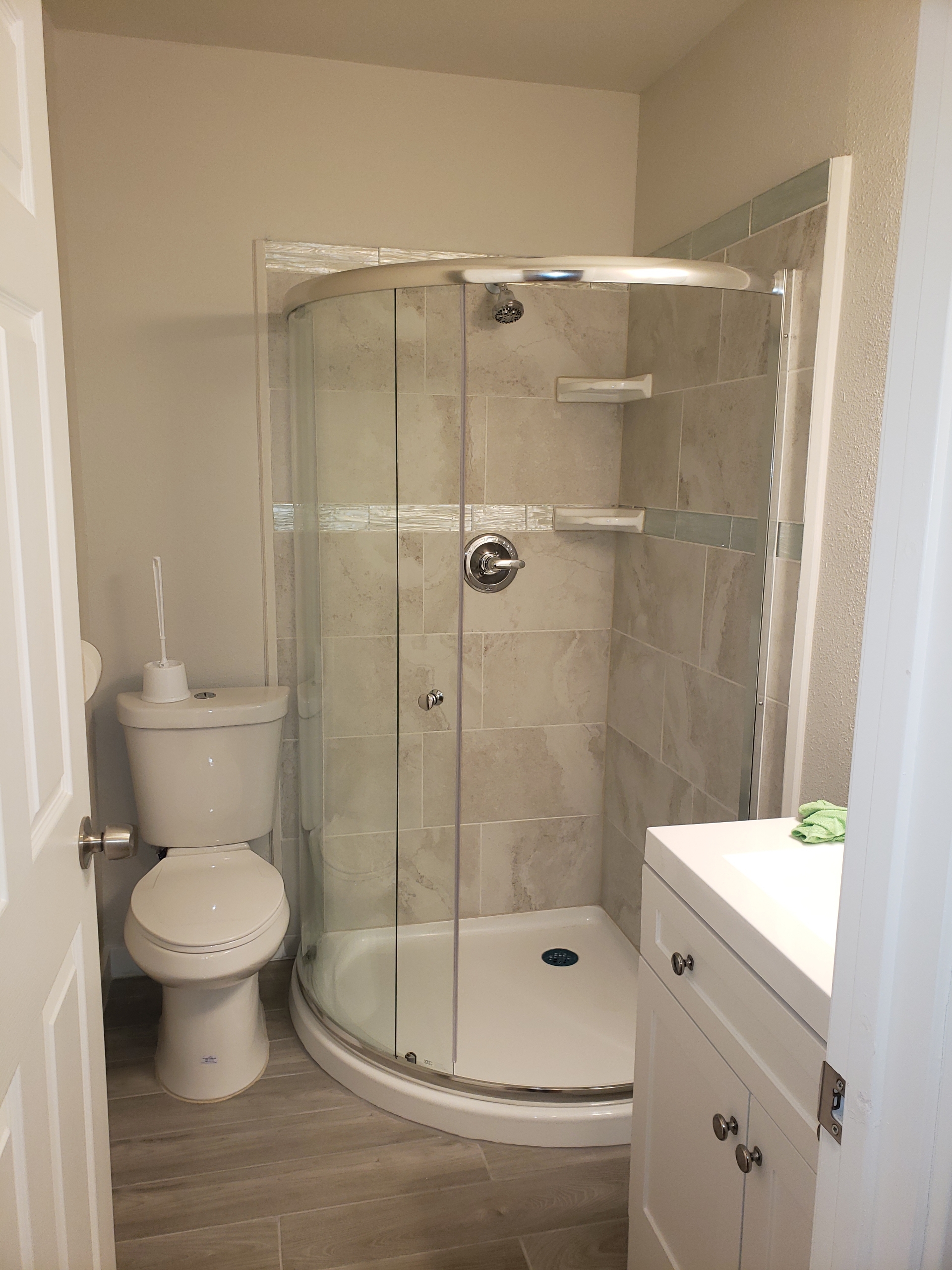 new luxure corner shower, toilet, and sink